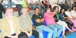 Chief guest Tom Alter watches the game along with other guests.
