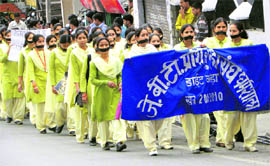 JBT trainees wear black bands on mouth, taking out a rally in support of their demands.
