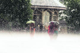People trying to escape from sudden hailstorm in Shimla on Wednesday. The entire state is feeling cold as the higher reaches have received fresh snow.