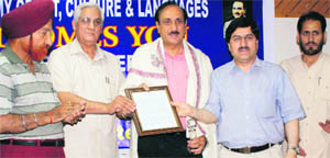 Pakistan-born Canadian poet Ashfaq Hussain (centre) being felicitated at a function in Jammu on Tuesday.