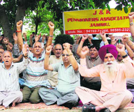 Members of the J&K Pensioners Association hold a demonstration in support of their pending demands at Rani Park in Jammu on Wednesday.