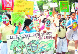 Students of Anee’s School, Mohali, with banners and placards, display messages to save the planet, on the occasion of the World Earth Day on Thursday.