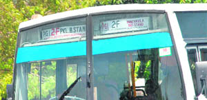 An old grid bus with a tiny board, displaying the areas it passes through in a hardly readable font.