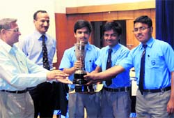 The Scholars Home team that won the 10th All-India Challenge Quiz held at RIMC receives the trophy from 