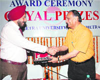 Prof Goverdhan Mehta (right), chairman, National Assessment and Accreditation Council and national research professor, gives away the Goyal prize to a winner at Kurukshetra University.