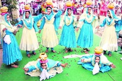 Girls performing at a district-level folk dance competition at Jahu 