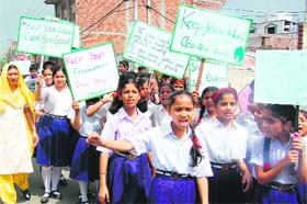 Students take part in an awareness rally on World Earth Day with a message, Global warming and Save Earth Planet, organised by the Kendriya Vidyalaya, Bantalab, in Jammu