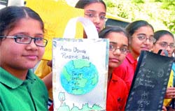 Students of Apeejay School, Rama Mandi, spread awareness on the use of paper bags instead of plastic bags on World Earth Day in Jalandhar on Thursday. Tribune photo: Malkiat Singh 