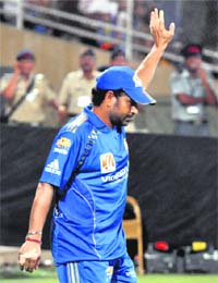 Mumbai Indians Sachin Tendulkar waves to the crowd after they defeated Royal Challengers Bangalore in the first semifinal of the IPL in Mumbai