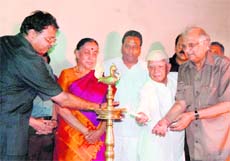 Uttarakhand Governor Margaret Alva watches as former Uttarakhand Chief Minister ND Tiwari lights a lamp at the inauguration of the Uttarakhand Film Festival in Dehradun on Friday. 