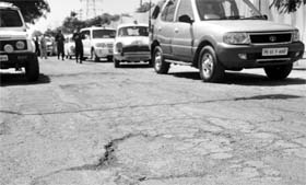 A potholed road outside the Punjab Forest Complex at Sector 68, Mohali. The complex was inaugurated by Punjab CM Parkash Singh Badal on Saturday.