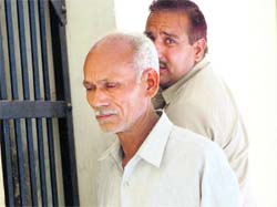 Congress leader Jagpal in police custody in Karnal on Saturday.