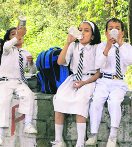 After a hard day at the school, it is natural to quench thirst. Schoolchildren are perhaps waiting for a bus or their parents after school hours at Dharamsala on Saturday.