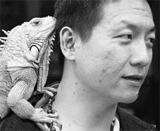 A man carries his pet iguana on his shoulder during the Love Animal Day pet carnival in Taipei on Saturday.