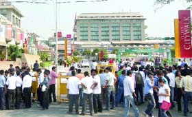 People wait outside a Saket mall while the cops search the place for bomb