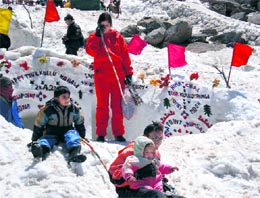 Tourists enjoy at snow point near Beas nullah, about 32 km from Manali, on Sunday. Photo: MC Thakur