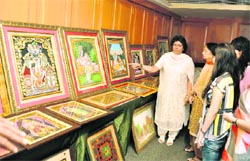 Rekha Arora with her paintings at an exhibition-cum-sale in Ludhiana.