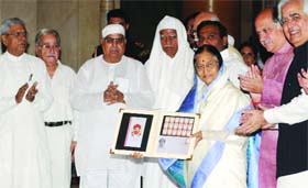 President Pratibha Patil releases a postal stamp of Sindhi holyman Kanwar Ram Sahib in New Delhi