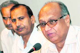 Haryana Election Commissioner Dharam Vir (right) addresses a press conference in Chandigarh