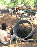 Residents make an underground tank to store water purchased by them during the summer months in a Mewat village