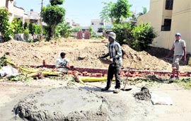 Construction work apace on a piece of land in Dugri, Phase II, for development of a park even after PUDA and the LMC have asked the residents to stop the work immediately in Ludhiana on Monday. Tribune photo: Himanshu Mahajan