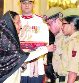 President Pratibha Devisingh Patil presents Kirti Chakra to Ajaz Ahmed and J&K girl Rukhsana Kausar at Defence Investiture Ceremony-II at Rashtrapati Bhavan in New Delhi on Monday. 