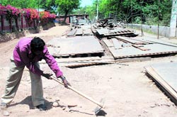 A labourer works at the under-construction approach road to IIT Ropar on Monday. Tribune photo: Vicky Gharu