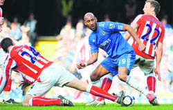 Chelseas Nicolas Anelka (2nd R) vies with Stoke Citys Danny Collins (R) and Rory Delap at Stamford Bridge in London on Sunday.