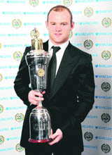 Manchester Uniteds Wayne Rooney holds his trophy after being named Professional Footballers Association, PFA, Players Player of the Year on Sunday in London.
