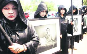 Environmental activists hold potraits of victims of the Chernobyl nuclear disaster during a protest to mark the 24th anniversary of the disaster in Jakarta on Monday. On April 26, 1986, a reactor at the Chernobyl nuclear complex in Ukraine caught fire, spreading aradioactive cloud across Europe in the worlds worst nulear diaster. 