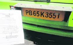 The registration certificate of a bus (PB-65-K-3557) and the tampered registration number displayed on it (PB-65-K-3551). The bus was impounded by the STA from the Sector 43 ISBT on Tuesday. 