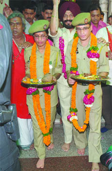 Jammu & Kashmir braveheart and winner of Kirti Chakra Rukhsana Kausar and her brother Ajaz Ahmed come out of a Hanuman temple in New Delhi on Tuesday.