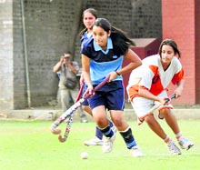 Girls vie for the ball during the Inter-council School Junior Girls Hockey Tournament in Dehradun on Tuesday. A Tribune photograph