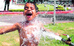 This boy seems to have found a way to keep himself cool on a hot afternoon in Jammu. Photo: Inderjeet Singh