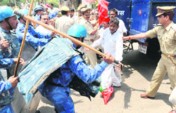 Rapid Action Force personnel baton charge Samajwadi Party activists during a nationwide bandh in Allahabad 