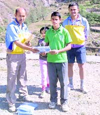 Pramod (in green T-shirt) receives a prize after winning the race organised by the Himalayan Running Club in Dehradun