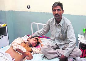 Ashok Kumar with his son, Karan Kumar, at Government Medical College and Hospital, Jammu