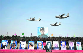 Afghan planes fly over pictures of dead leaders of Afghanistan during an official ceremony marking the 18th anniversary of the defeat of the communist regime in Afghanistan, in Kabul's sport stadium on Wednesday. 