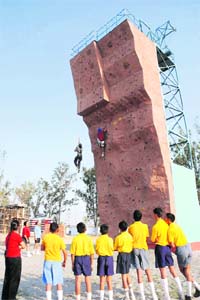 Students practise lead climbing and jumaring on an artificial climbing wall at Sainik School, Kunjpura (Karnal)