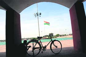 A cyclist rests on the banks of Brahmasarovar on a hot afternoon in Kurukshetra