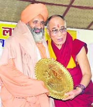The Dalai Lama honours environmentalist Balbir Singh Seechewal at a function to mark 50 years of their exile at Dharamsala on Thursday.