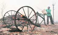 A man tries to salvage his rehri after a massive fire at Hussainpura in Ludhiana 