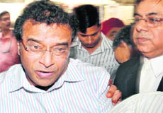 Joint Secretary (Disaster Management) in the Ministry of Home Affairs O Ravi being taken away after being produced in the Metropolitan Magistrates court at Patiala House by the CBI in New Delhi on Thursday.