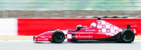 Britain's Prince Andrew sits behind former Formula One driver Damon Hill on the new Silverstone F1 GP circuit in central England on Thursday.  Reuters