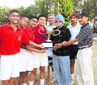 Olympian Hardayal Singh (in blue turban) gives away the trophy of the Inter-section Hockey Tournament to the team of Ranjit Section at RIMC in Dehradun on Friday.