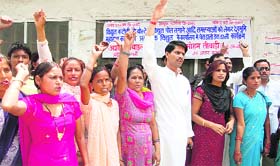 Residents of villages around Nakroda protest against low-voltage power supply in Dehradun on Friday.