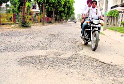 Main and feeder rods in Dugri Urban Estate full of pot holes. Photo: Inderjeet Verma