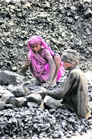  Labourers work in a coal mine on the eve of International Labour Day near Allahabad on Friday. 
