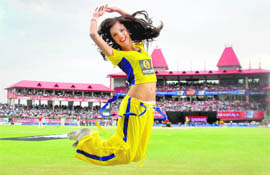 An IPL cheerleader brings colour to the air at the cricket stadium at Dharamsala