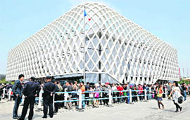 Visitors queue up to enter the French pavilion on the first day of the World Expo 2010 in Shanghai on Saturday.